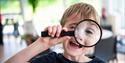 child with magnifying glass