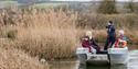 A group on a boat tour among the reeds at WWT Arundel Wetland Centre