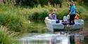 A group of people on a boat tour at WWT Arundel Wetland Centre