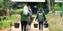 Staff & Mind Gardening Group participants carrying buckets in the Community Garden at London Zoo