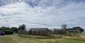 Some of the pods at Experience Freedom Glamping at Cayton Village with the surrounding countryside