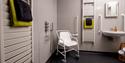 Accessible bathroom at Elderburn Lodges which includes a shower chair and hand rails