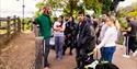 A group of people with a guide dog on an Audio Described Tour at London zoo