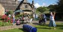 Beamsley Project's open day. Shows people enjoying the garden with bubbles and garden furniture