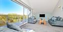 Queenwood Holidays living area with balcony and river views