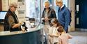 family buying tickets for Jersey Heritage Maritime Museum