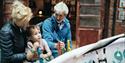 Family with small child looking at the displays at Jersey Heritage Maritime Museum