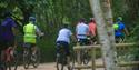 A group of people cycling through Moors Valley Country Park and Forest