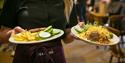 Waitress delivering food in the cafe at Moors Valley Country Park and Forest