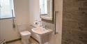 bathroom with hand rails ar North Hayne Farm Cottages