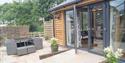 patio and decking area with a ramp down to the seating at North Hayne Farm Cottages