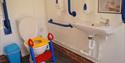 toilet with handrails and child assistance equipment at North Hayne Farm Cottages