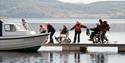 Group, including two wheelchair users boarding a boat at. Calvert Kielder