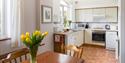 Hall Farm Cottage Dining Room with some yellow tulips on the table.