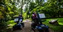 A couple using all terrain Mobility Scooters at Westonbirt Arboretum