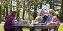 Family enjoying a picnic at Arlington Court and the National Trust Carriage Musuem

