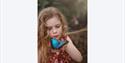 child holding a butterfly at Jersey Zoo