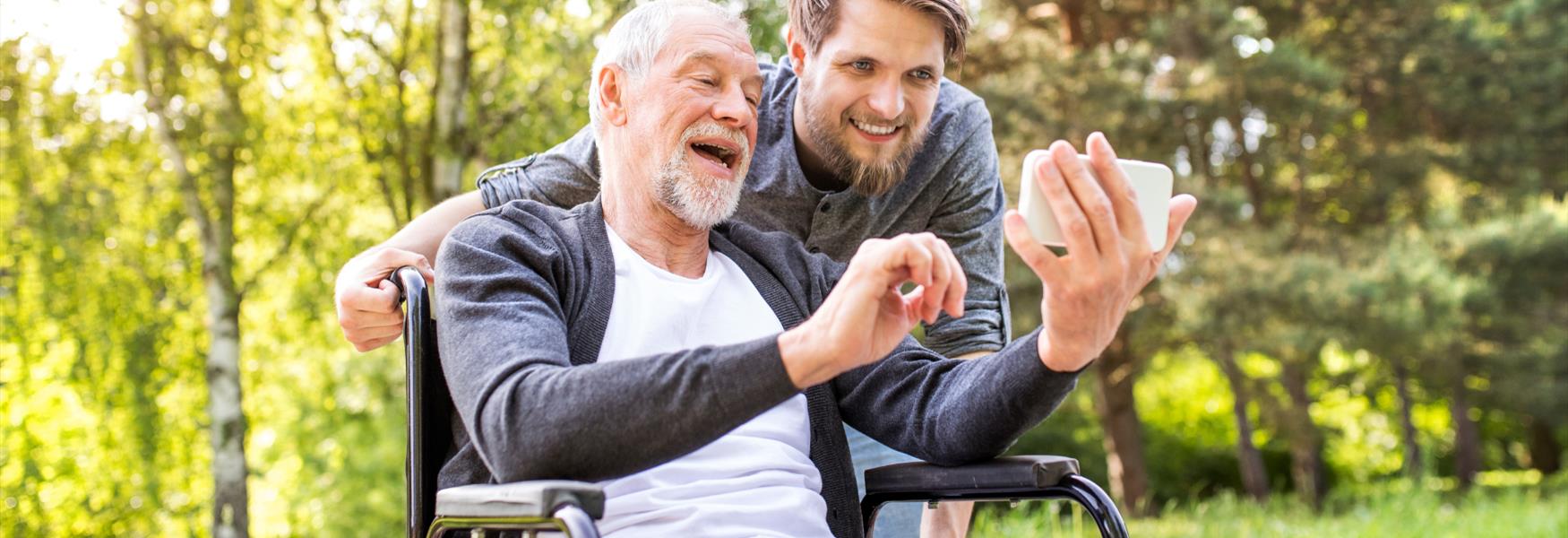old man in wheelchair with young man