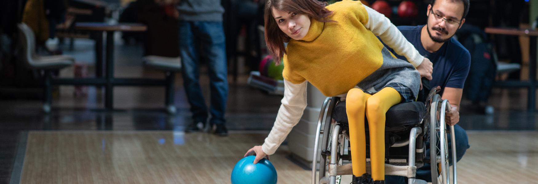 Lady in wheelchair playing ten pin bowling