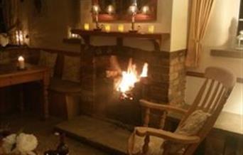Relax by the open fire with a glass of wine.