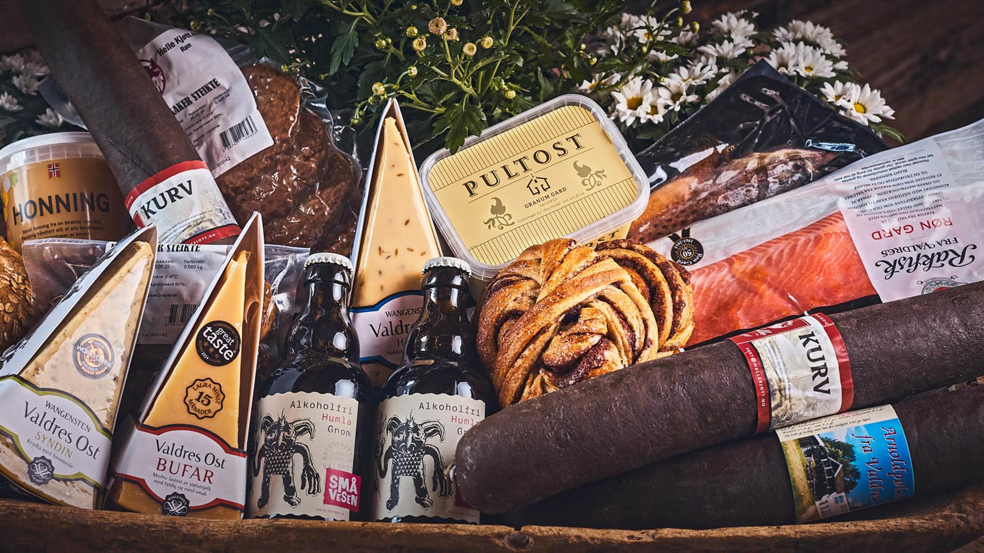 Tray with local produce - sausage, beer, cheese, honey, rolls and semi-fermented trout