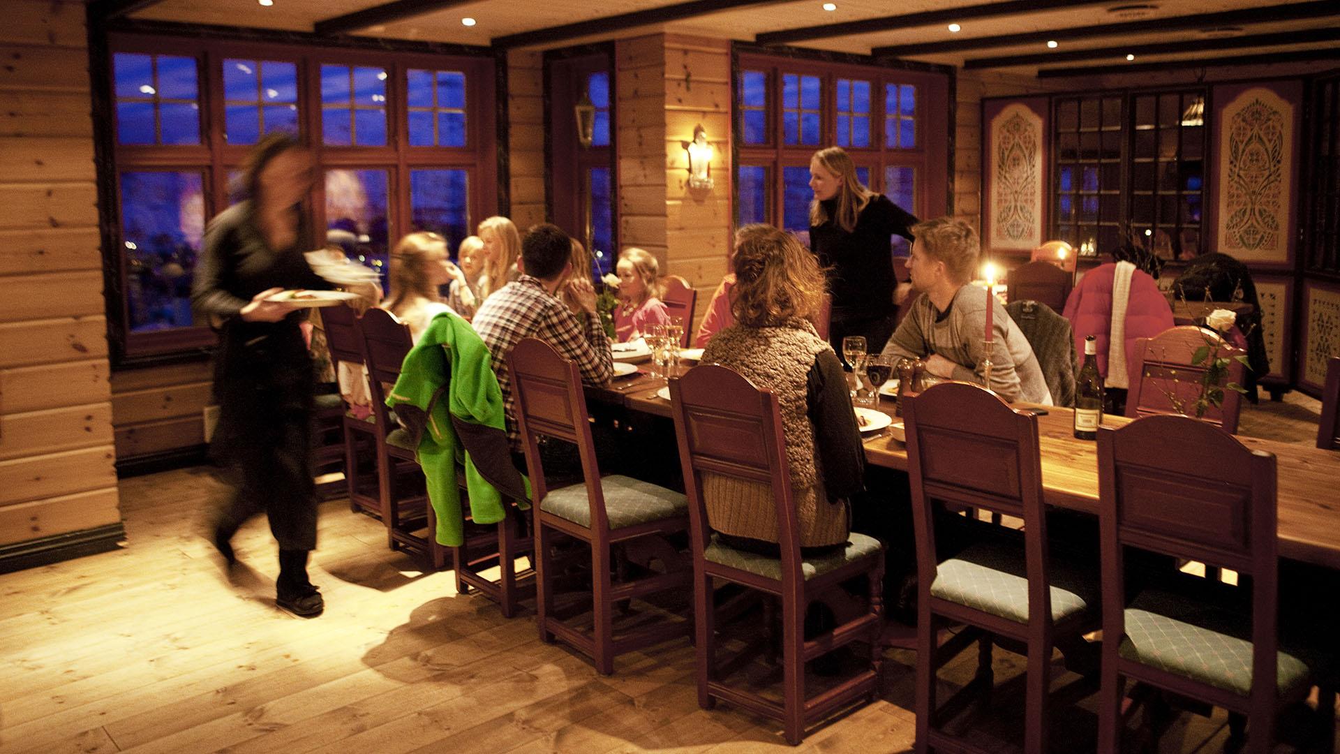 Group of people being waited on at a eatery.