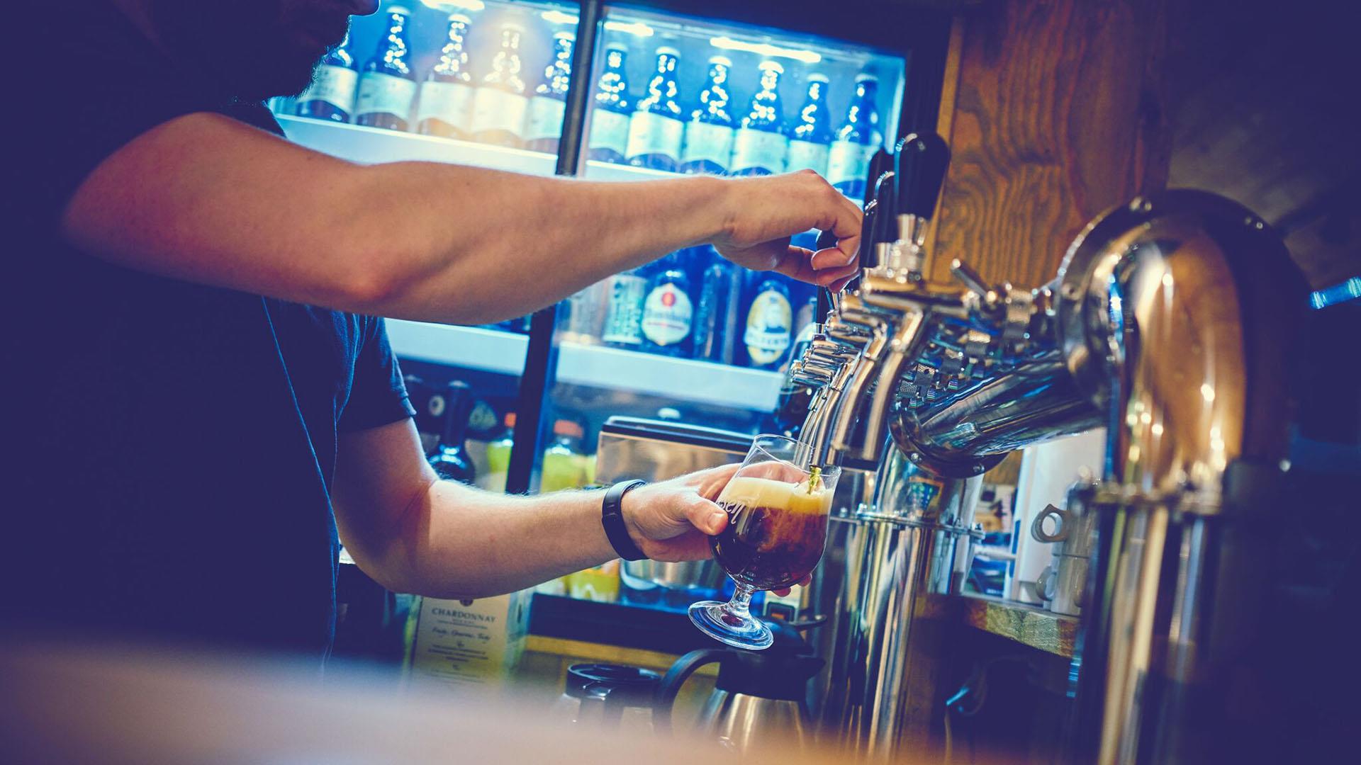 Man tapping beer from a beer tap.