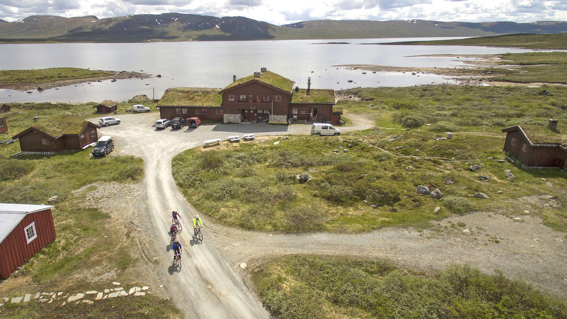 Cyclists on their way from a mountain lodge backon the gravel