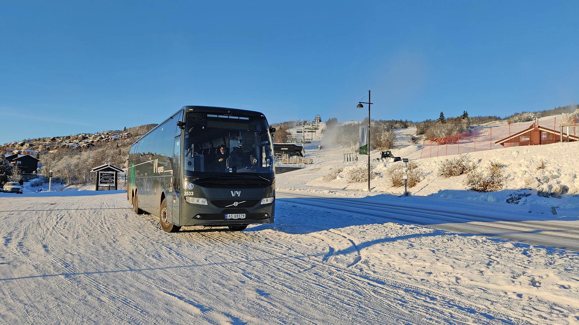 Modern long distance coach in front of ski lift