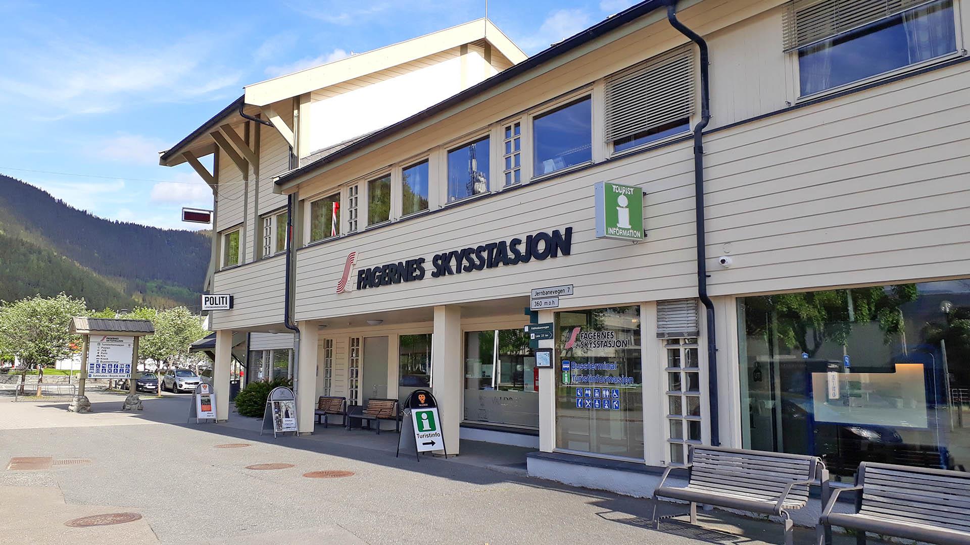 Ein hellbeiges, zweistöckiges Holzgebäude in Fagernes beherbergt das Busterminal und die Touristinformation.