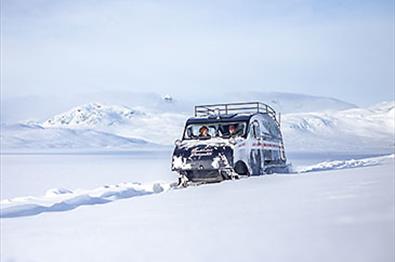 Snow coach in snowy mountain landscape