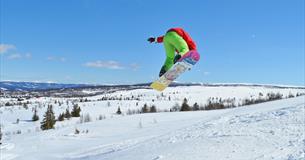 Person jumping on a snowboard