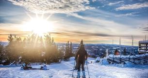 Alpine skier with an amazing view against the winter sun.
