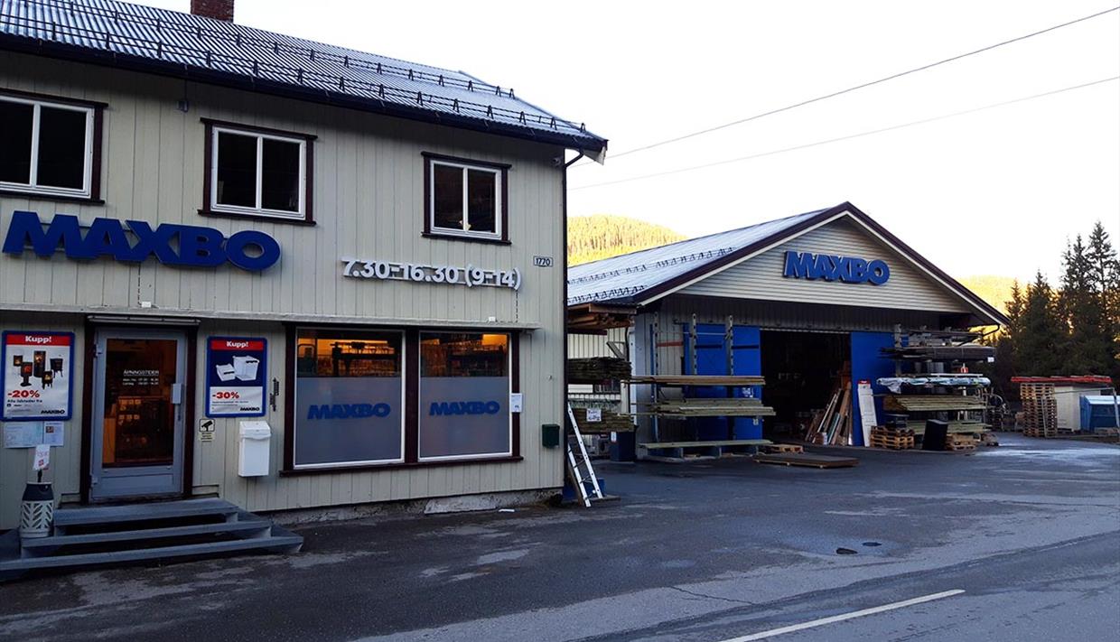 Hardware and building supplies store with light wooden panelling from the outside.