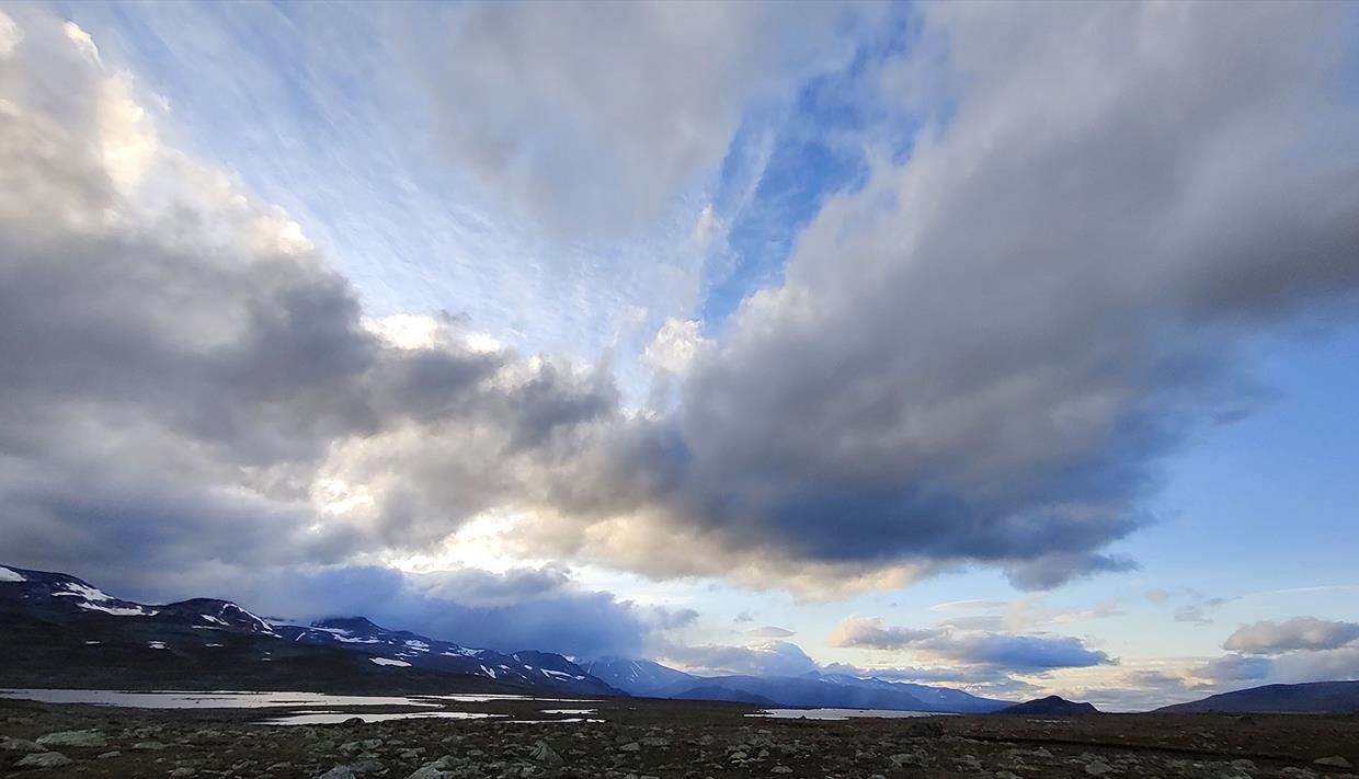 Mountain plateau with lakes and high skies with lots of cool clouds and magical light