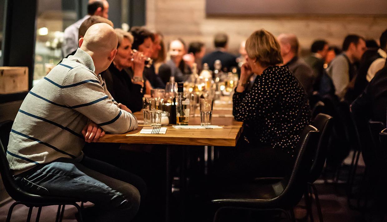 People enjoying food and drinks inside Lodge 900