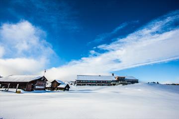 Oset Fjellhotell utvendig med snø og blå himmel