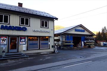 Hardware and building supplies store with light wooden panelling from the outside.