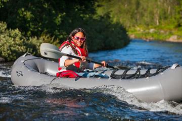 Lady in a pack raft in a river