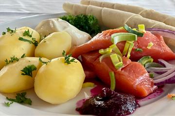 Rakfisk plate with boiled potatoes, semi-fermented trout and sides