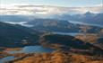 View from the summit to many lakes and lower and higher mountains.