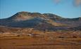 Skaget rises over the summer mountain farming area of Vesleskag. The vegetation is autumn coloured, and the first snow has fallen on the high altitude