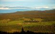 View from Brattstølen towards small farms on the other side of the Valley Tisleidalen in teh evening sun.