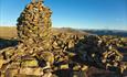 Next to the impressive summit cairn at Gråkampen there's built a wall of rocks to create a wind-sheltered place for a rest.