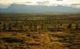 View from Gribbe over a large plain towards a mountain chain.