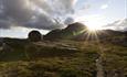 A mountain against the sun. The sunrays are reflected in the form of a star