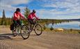 Two cyclists on the road along Pardisfjorden.