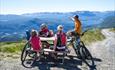 Rest at the highest point of the mountain pass road Slettefjellvegen with a breathtaking view into the valley below and mountains far behind.