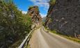 Cycling along steep rock cliffs along Lake Vangsmjøse.