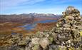 At Tyinstølsnøse with a view over lakes and mountainous landscape to the pointed peaks og Hurrungane.